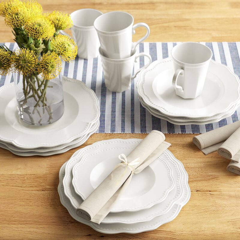 Red Vanilla Classic 16 Piece Dinnerware Set, Service for 4 sitting on table blue striped table runner