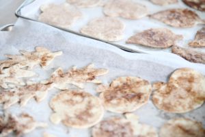 Unbaked cinnamon sugar tortilla chips on baking sheet