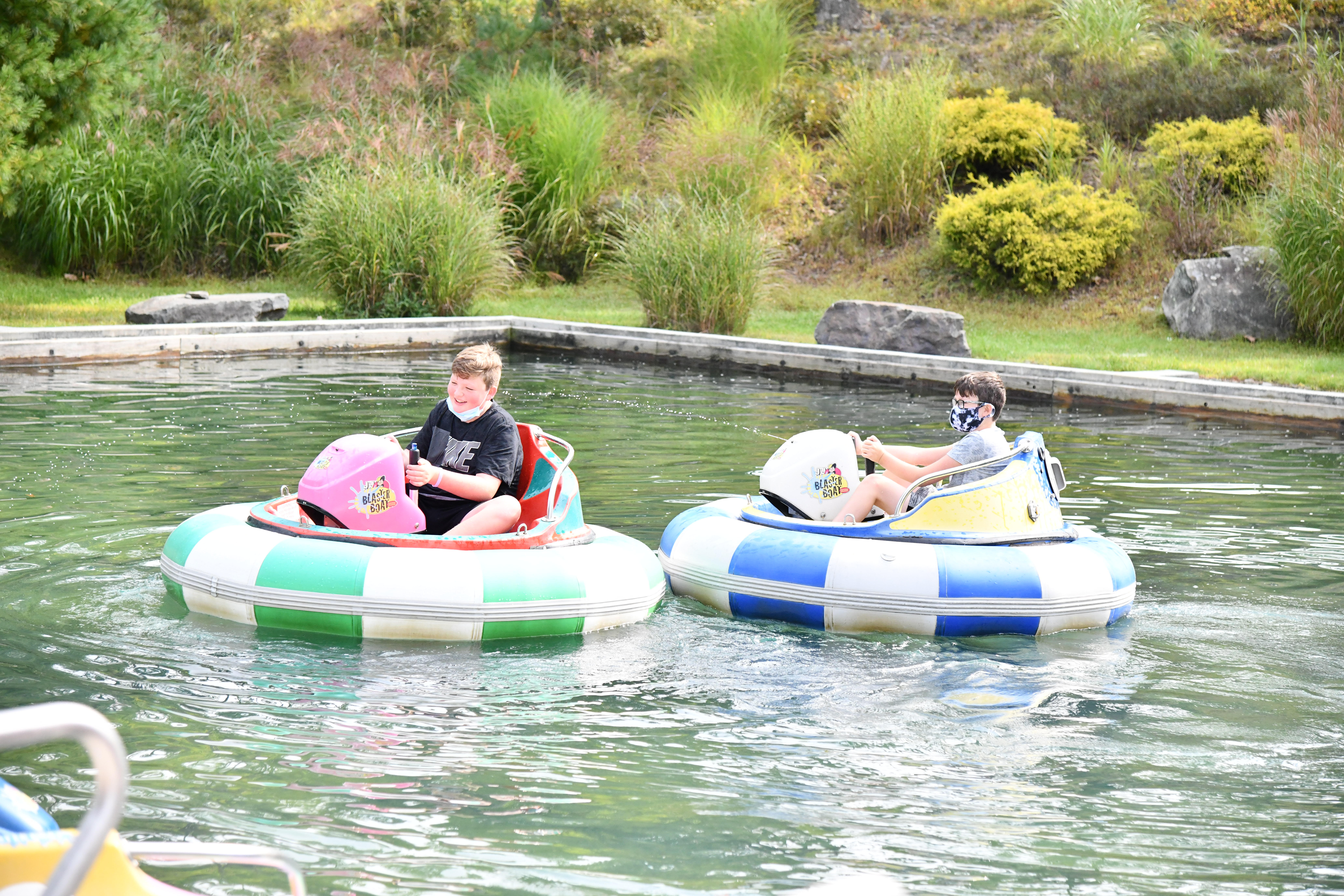 Two boys in bumper bots on water at Woodloch Resort in Poconos