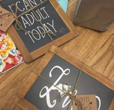 Sign laying on the floor chalkboard saying can't adult today and love 
