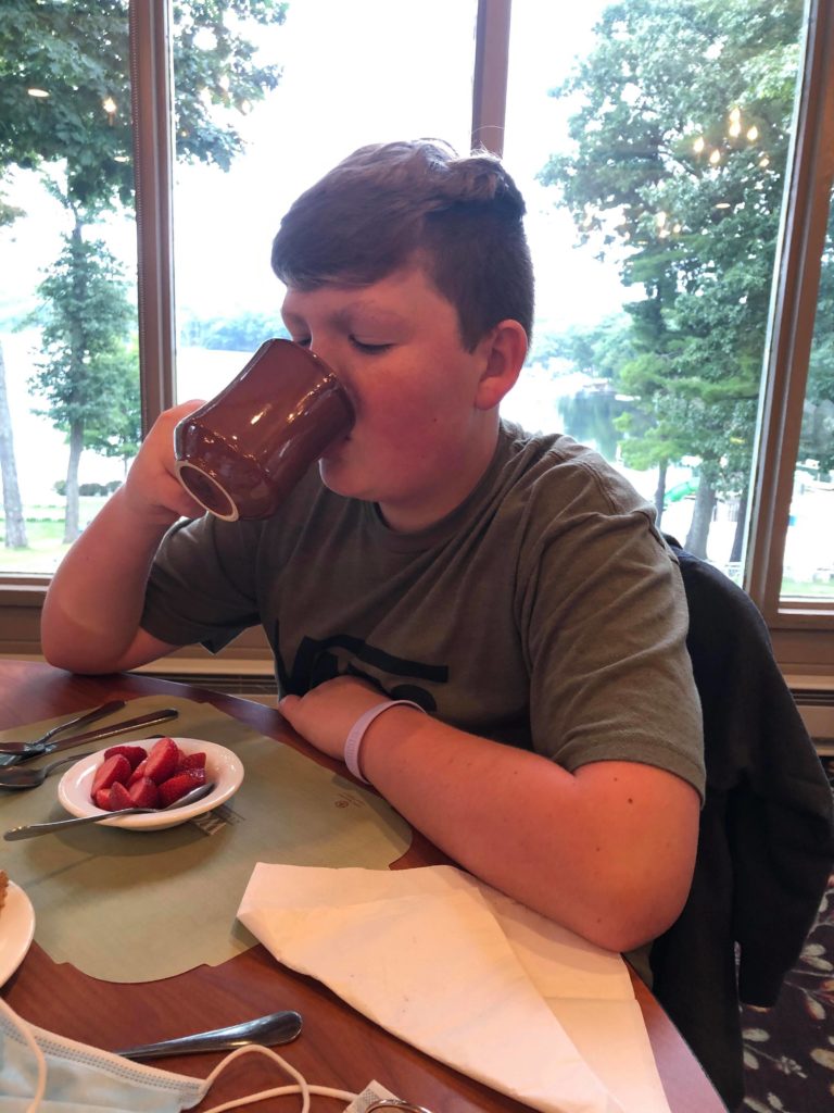 Woodloch kid drinking hot chocolate