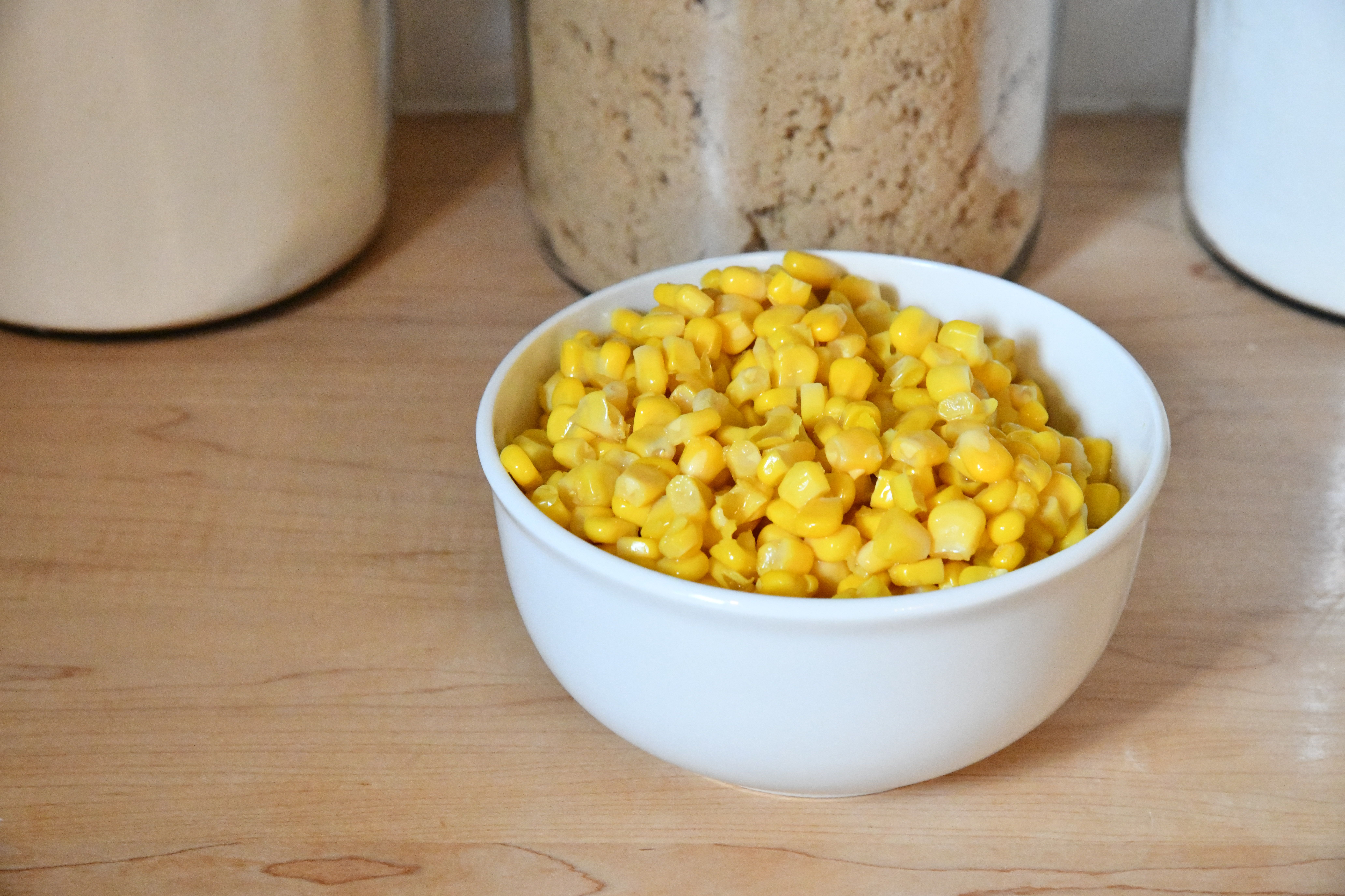 Corn in white bowl on kitchen counter