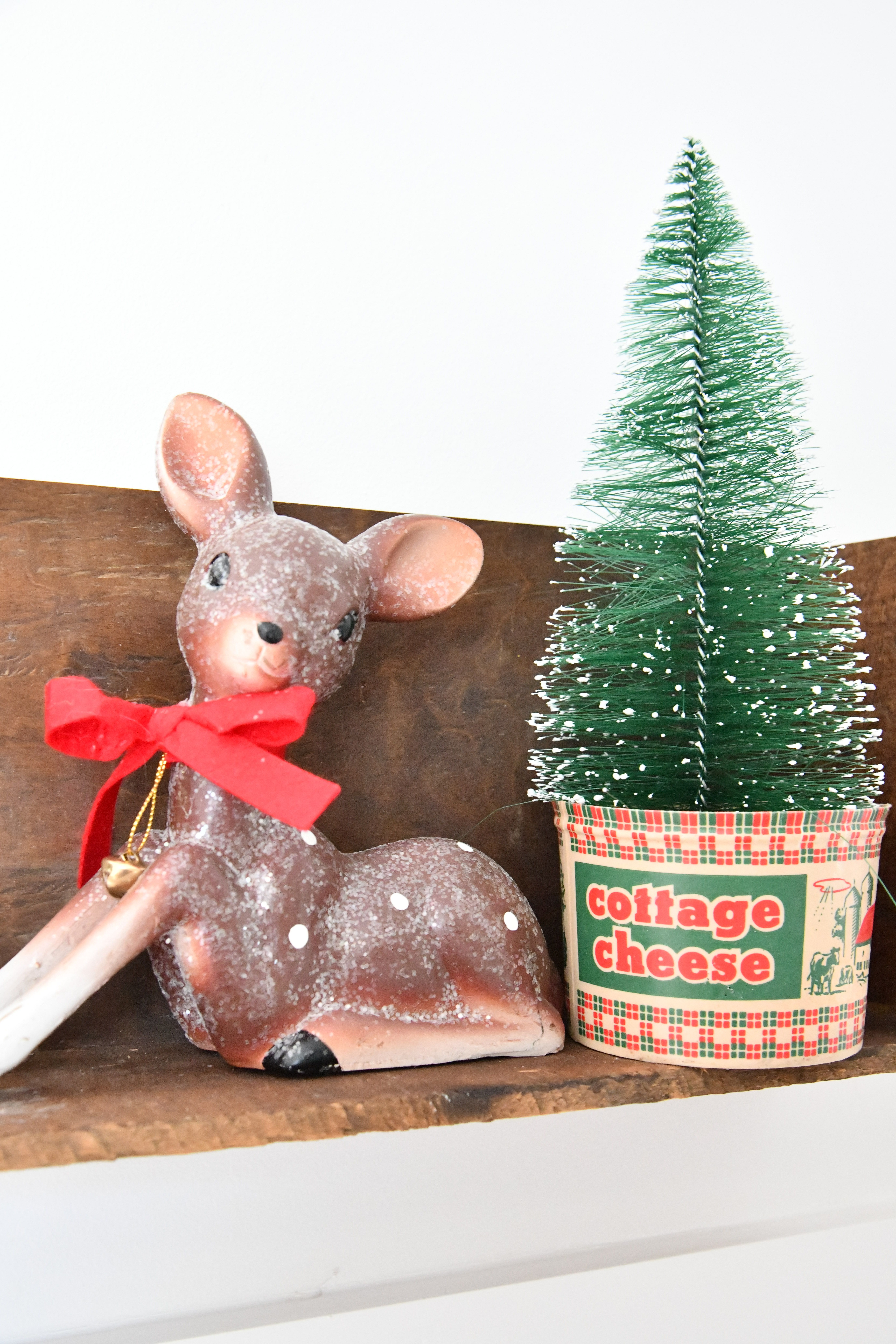 Vintage Christmas Tree Stands Mini Tree in vintage cottage cheese container with deer on shelf 