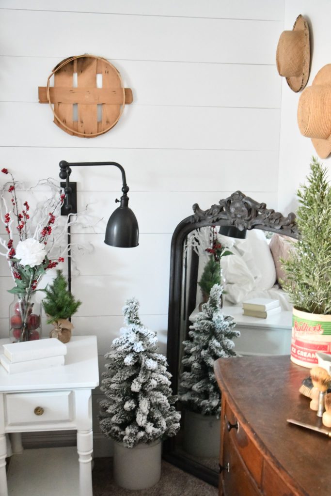 Farmhouse bedroom large mirror and christmas tree on floor in rock white end table