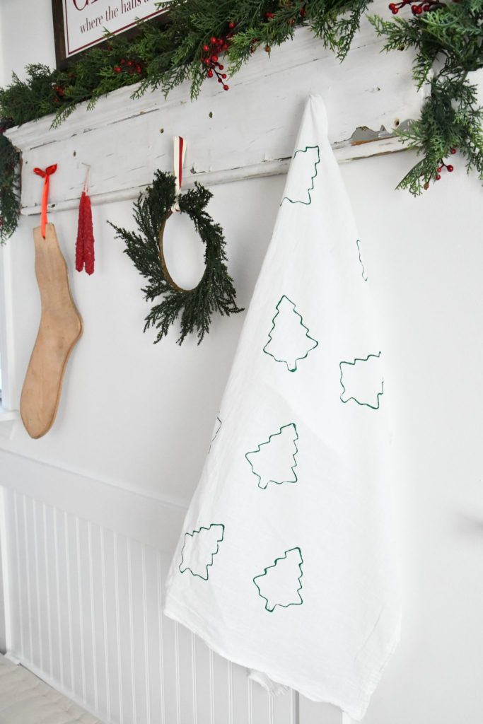 Tea Towel with green christmas trees hanging on rack