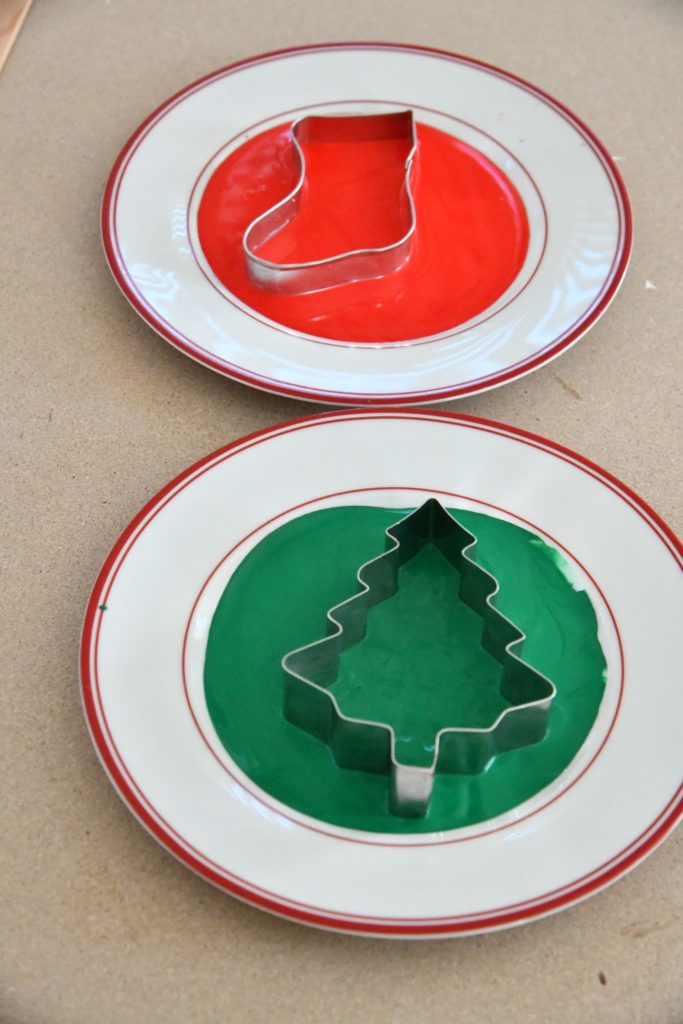 cookie cutters in red and green paint on plate