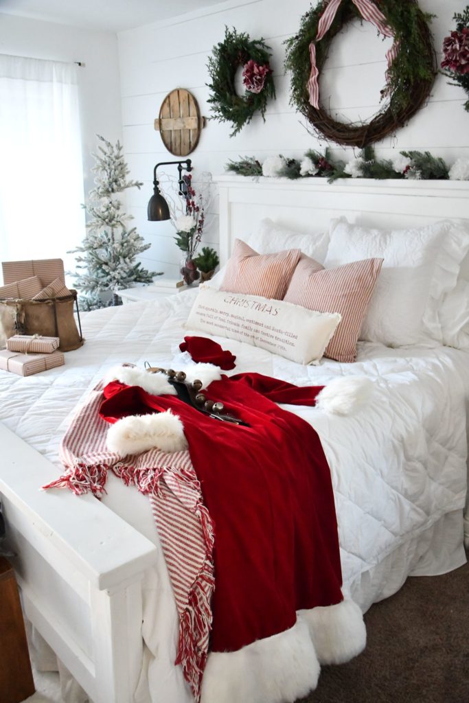 Mrs. Santa clause suit sitting on bed farmhouse Christmas master bedroom reveal