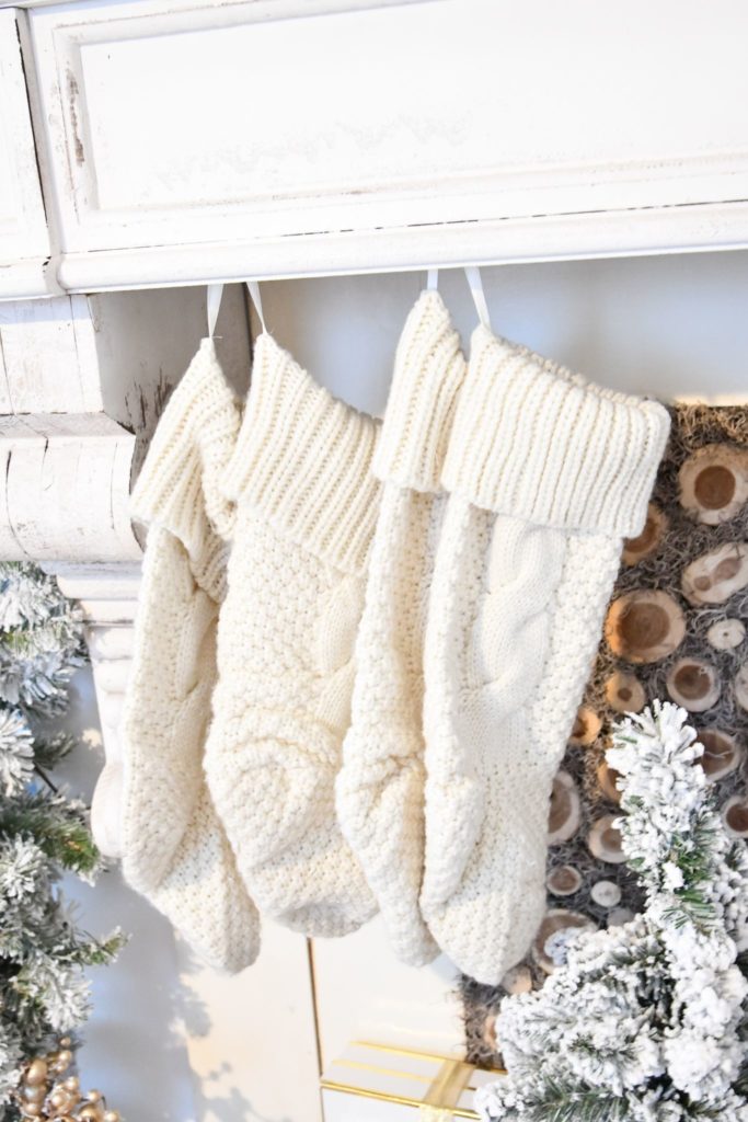 White cozy knit cable stocking hanging off mantle