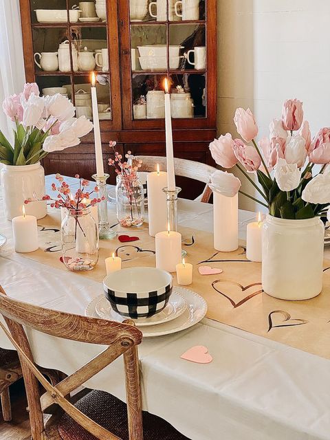 French farmhouse valentines day table with pastel pinks, simple dinner settings and candlelight