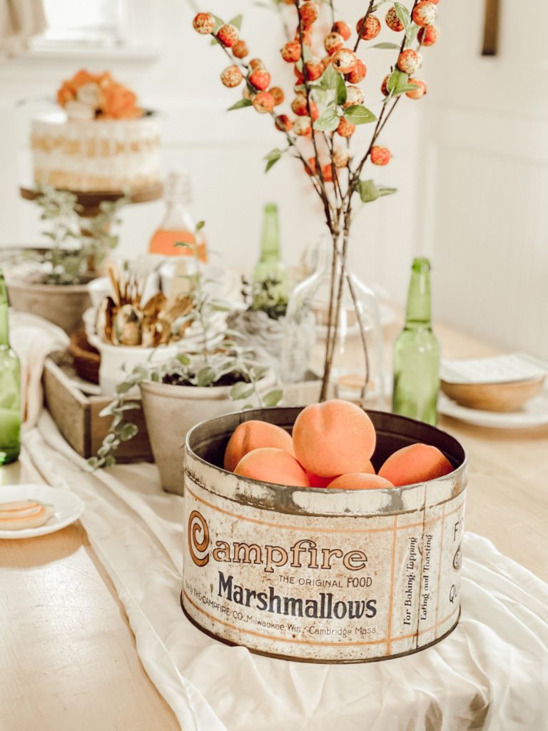If You Love Peaches You Will Love this Tablescape campfire marshmallow vintage tin on peach decorated table