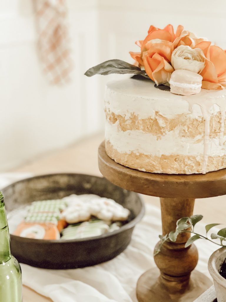 peach faux cake on wood cake stand