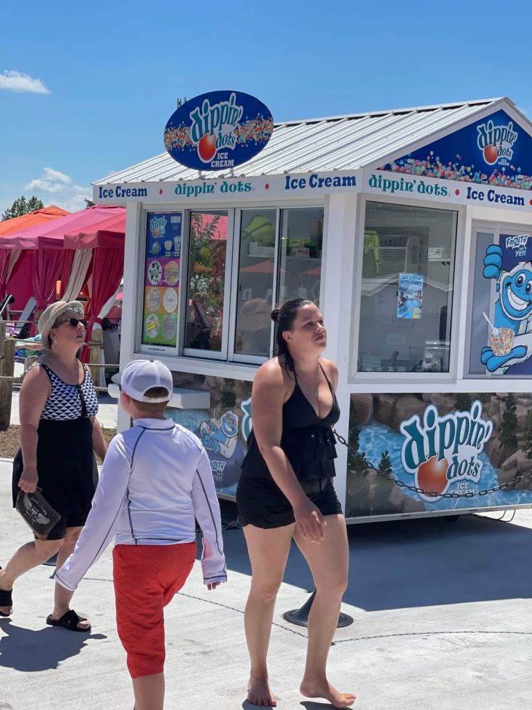 Dippin' dots mobile set up shop and people walking by