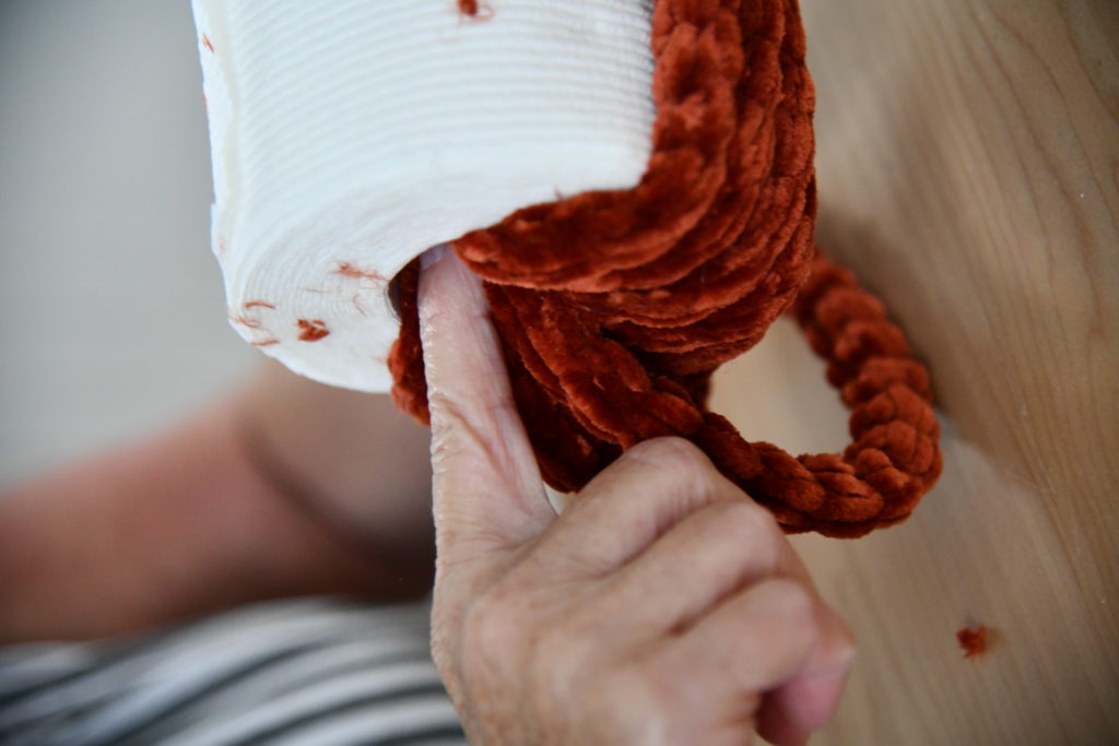 DIY Toilet Paper yarn Pumpkin push yarn through middle hole
