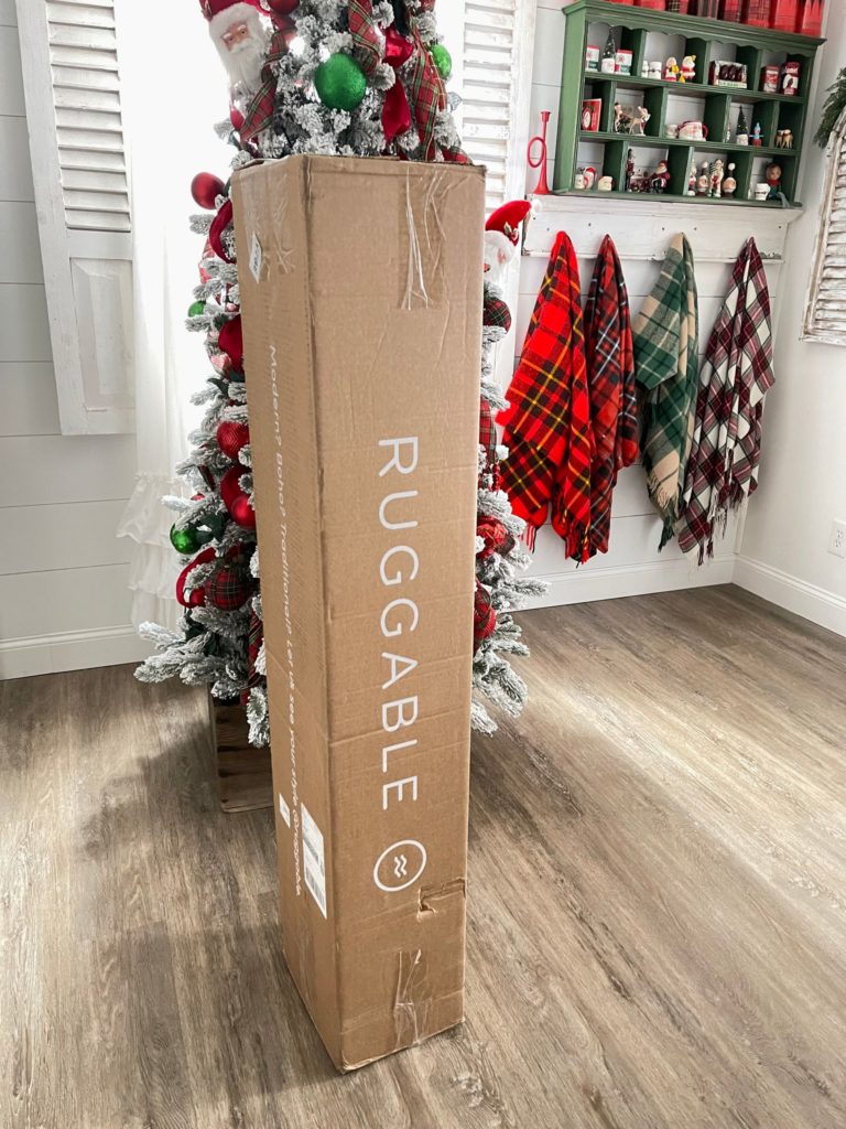 huggable box standing in front of a Christmas tree