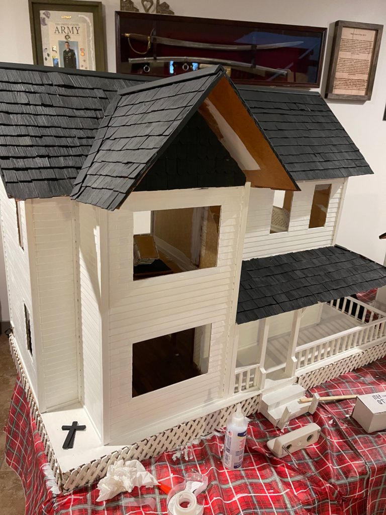front view of dollhouse with black roof