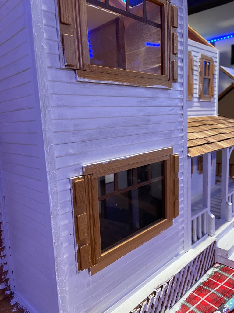 Close up from tof dollhouse with one coat white paint on it