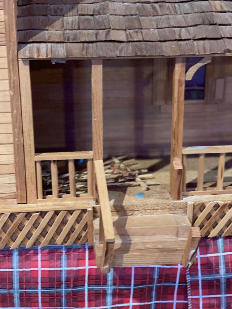 front porch of dollhouse close up before remodel stairs broken