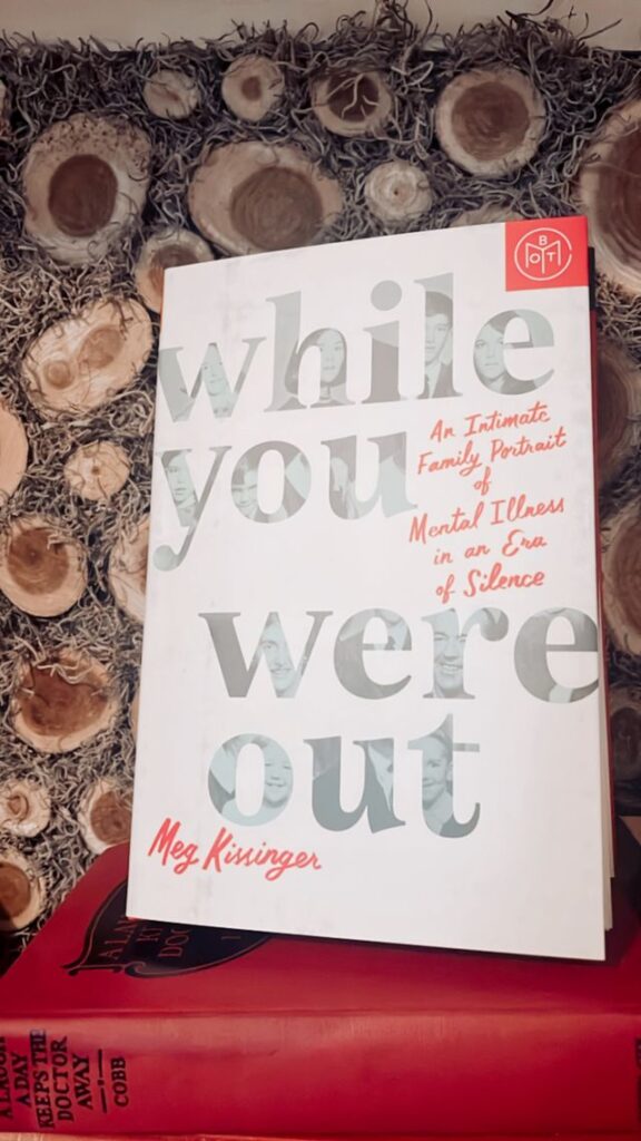 While you were out book by Meg Kissinger on a mantel