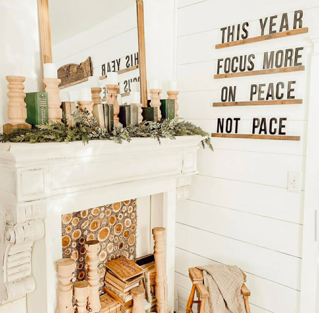 Simple farmhouse mantle styled with greenery, warm wood tones, and neutral decor
Cozy farmhouse mantle with natural greenery and rustic wood accents
Minimal farmhouse mantel decorated with soft green accents and vintage wood pieces